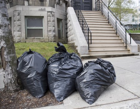 Builders using dumpsters for waste clearance in Chigwell project